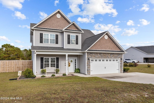 craftsman-style home with a garage, covered porch, and a front lawn