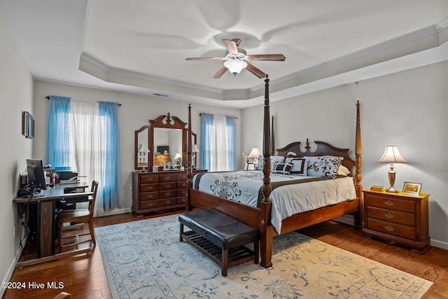 bedroom with hardwood / wood-style floors, multiple windows, ornamental molding, and ceiling fan