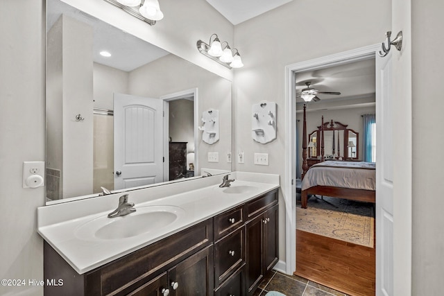 bathroom with wood-type flooring, vanity, and ceiling fan