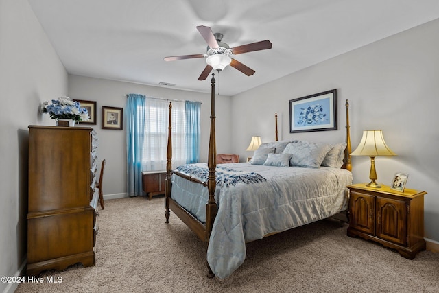 bedroom featuring ceiling fan and light carpet