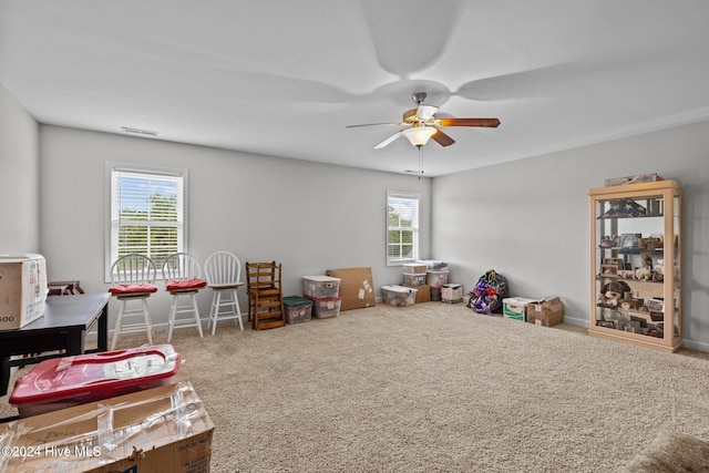 game room featuring carpet flooring, ceiling fan, and a wealth of natural light