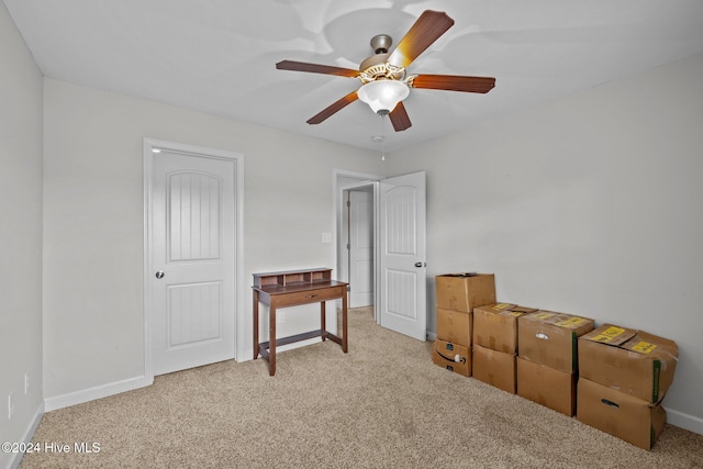 interior space with ceiling fan and light colored carpet