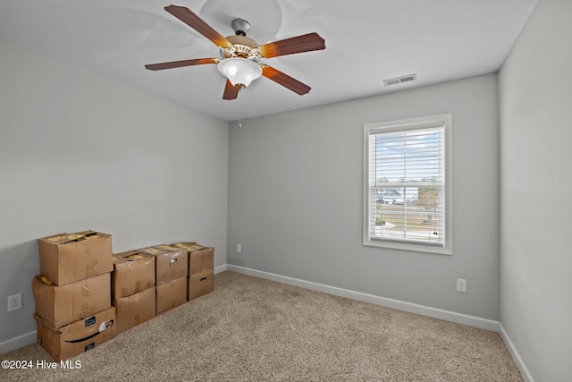 empty room with ceiling fan and light colored carpet