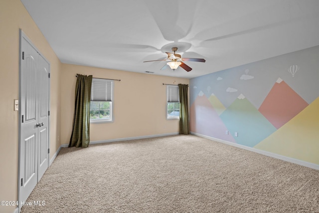 empty room featuring carpet and ceiling fan