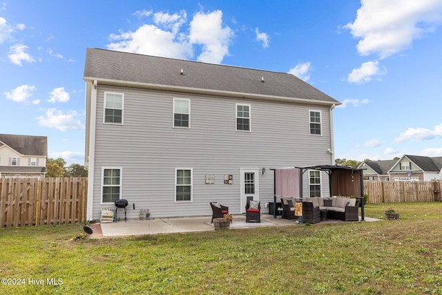 back of house with a lawn, a patio area, and an outdoor hangout area