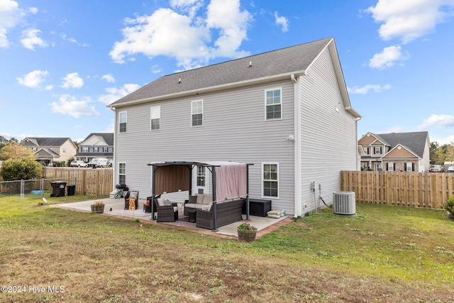 back of property featuring central air condition unit, a patio area, a yard, and an outdoor hangout area