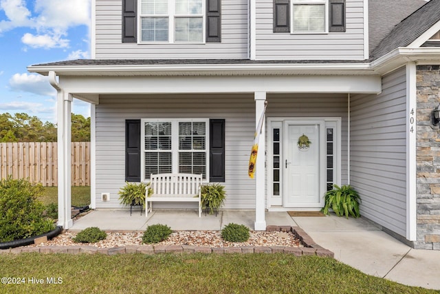 doorway to property featuring covered porch