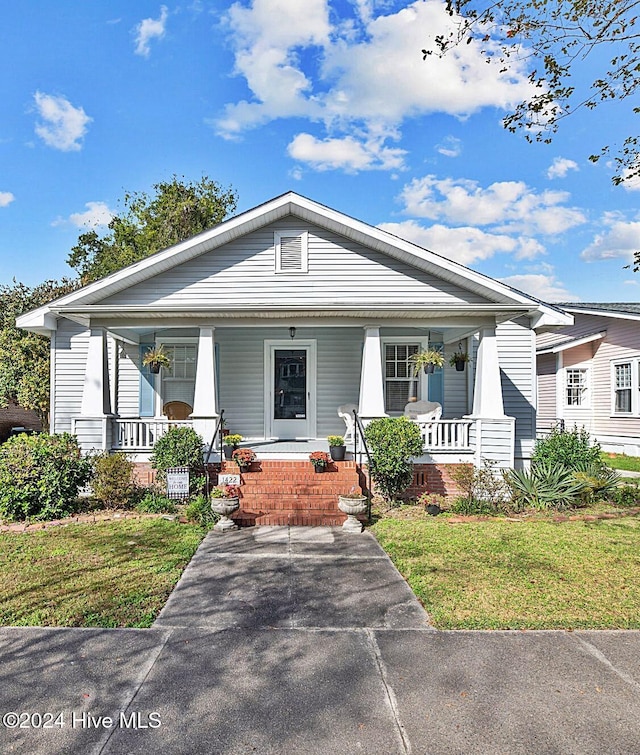 bungalow-style home with a front lawn