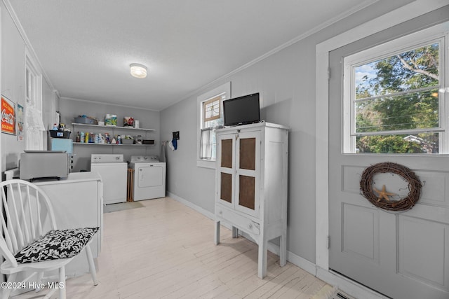 laundry room with separate washer and dryer and ornamental molding