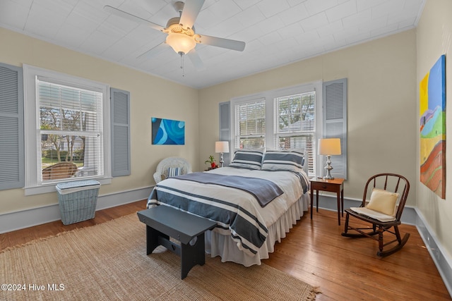 bedroom with ceiling fan and hardwood / wood-style floors