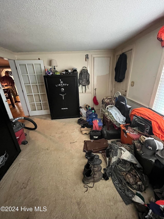 bedroom featuring carpet floors and a textured ceiling