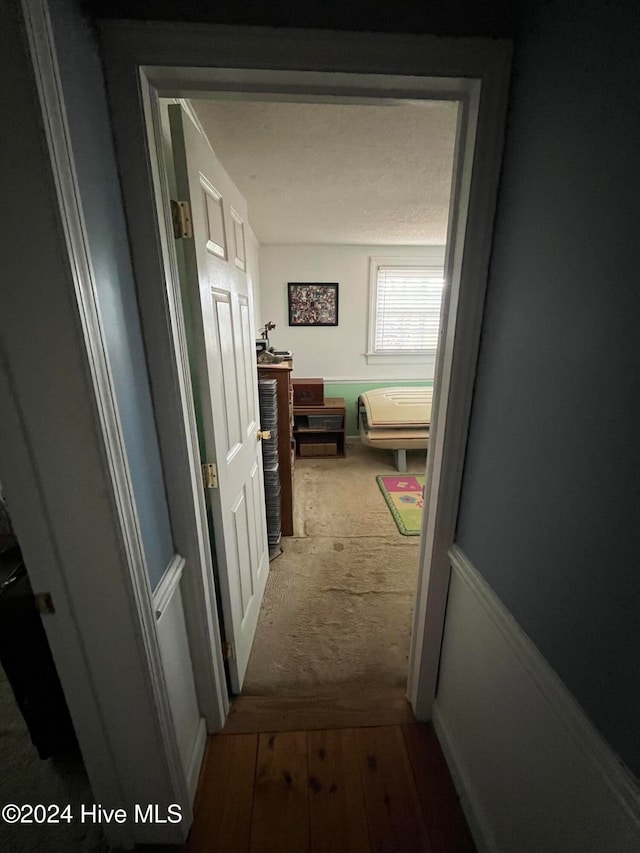 corridor with hardwood / wood-style floors