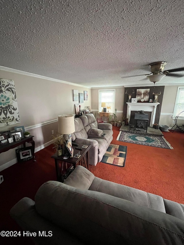 living room with ceiling fan, carpet floors, a textured ceiling, and ornamental molding