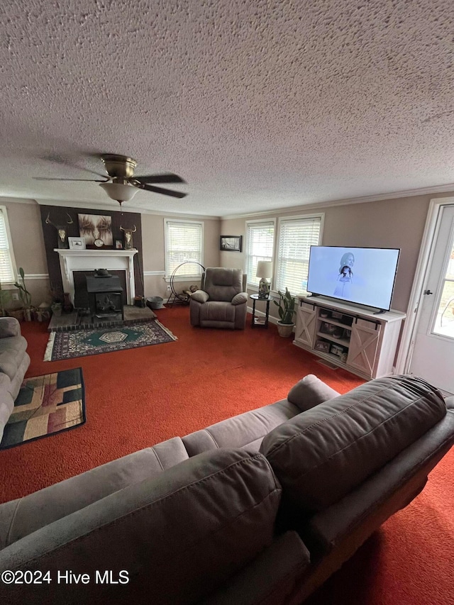 living room with ceiling fan, carpet floors, a textured ceiling, and a wealth of natural light