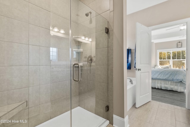 bathroom with tile patterned floors and a shower with door