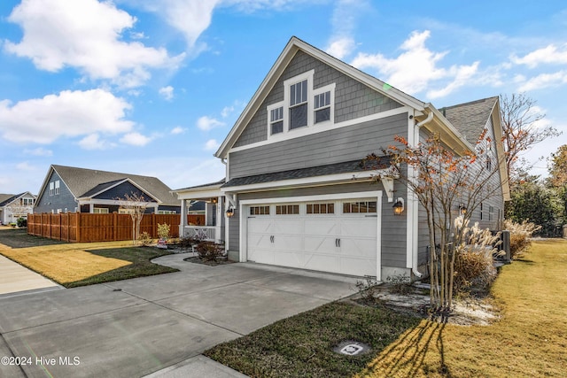 view of front of home with a front lawn and a garage