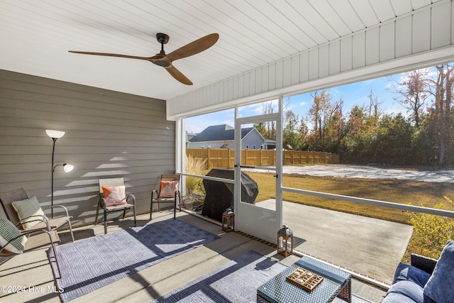 sunroom / solarium with ceiling fan and wood ceiling