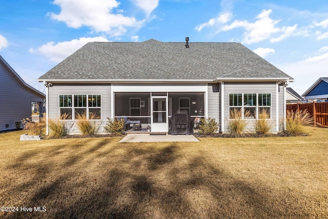 back of house with a sunroom, a yard, and a patio