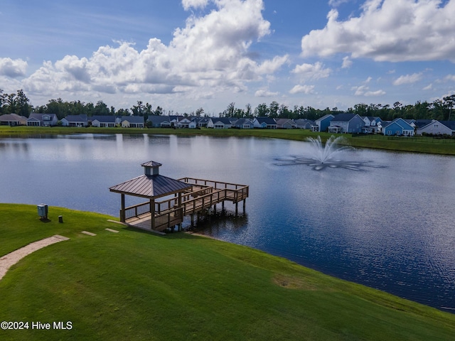 dock area with a water view and a yard