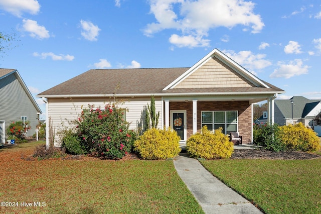 view of front of property with a front yard and a porch