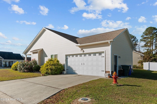 view of property exterior featuring a yard and a garage