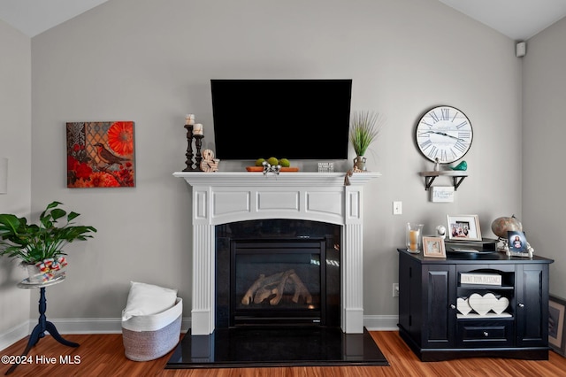 living room with hardwood / wood-style floors and vaulted ceiling