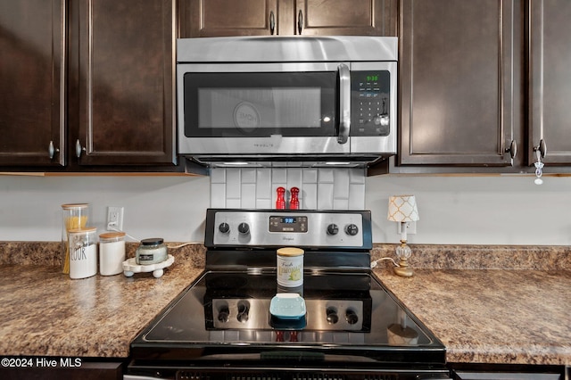 kitchen with dark brown cabinetry, stone countertops, and appliances with stainless steel finishes