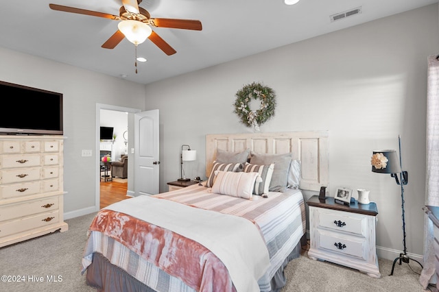 bedroom with light carpet and ceiling fan