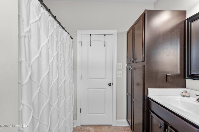 bathroom with tile patterned floors and vanity