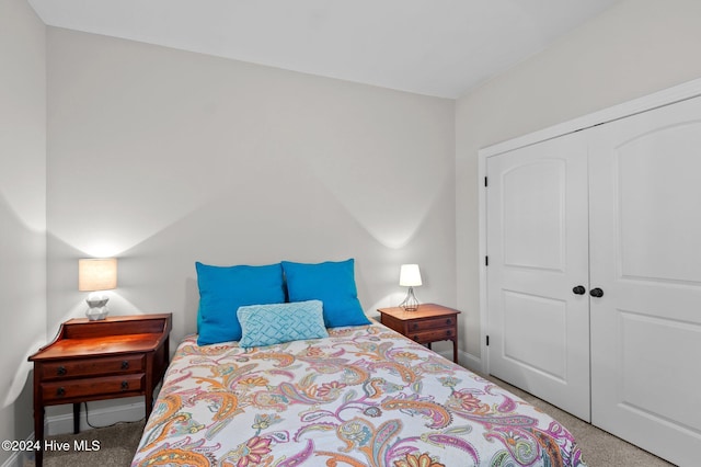 carpeted bedroom featuring a closet