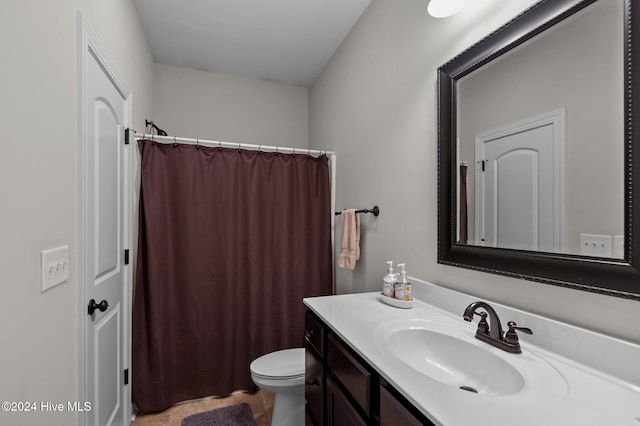 bathroom with vanity, toilet, and a shower with shower curtain