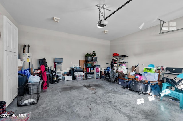 garage featuring water heater and a garage door opener