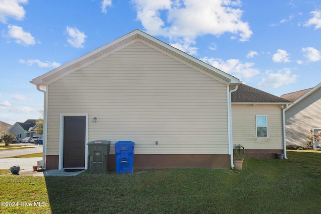 view of property exterior with a yard