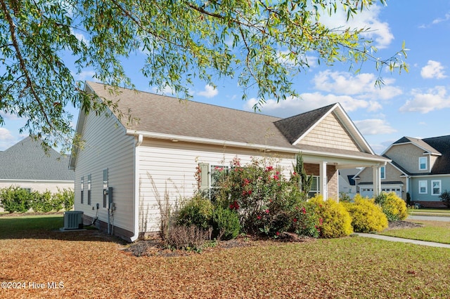 view of front of house featuring a front lawn and cooling unit