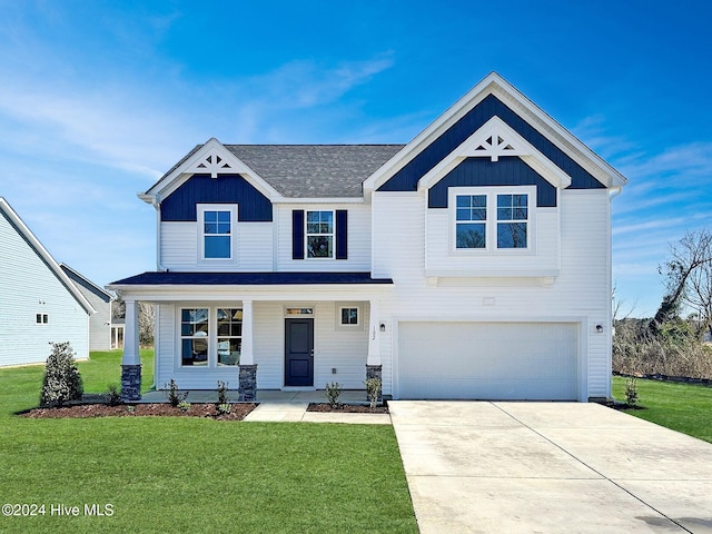 view of front of house with a garage and a front lawn