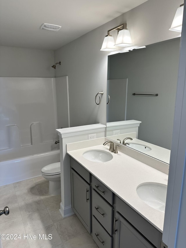 full bathroom featuring toilet, shower / tub combination, vanity, and tile patterned flooring