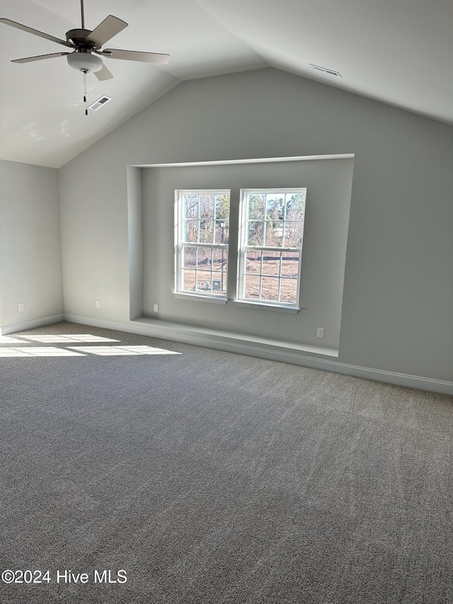 unfurnished room with vaulted ceiling, ceiling fan, and carpet floors