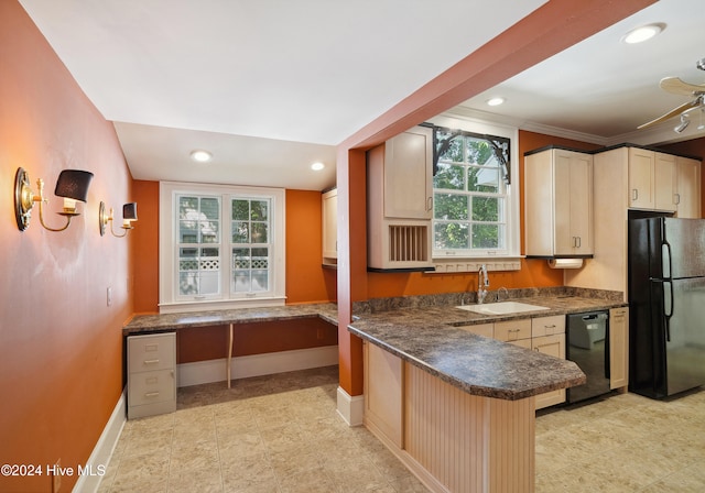 kitchen featuring a wealth of natural light, sink, black appliances, and kitchen peninsula