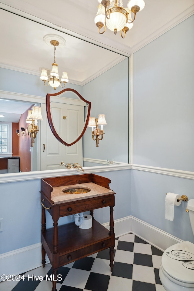 bathroom featuring ornamental molding, a chandelier, and toilet