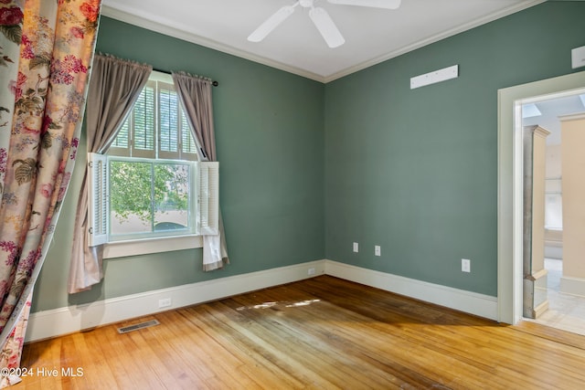 spare room with ornamental molding, hardwood / wood-style floors, and ceiling fan