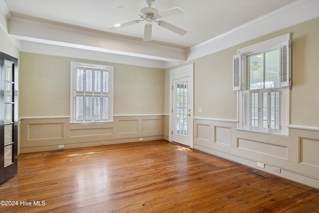 unfurnished room with ornamental molding, hardwood / wood-style flooring, ceiling fan, and beam ceiling