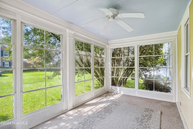 unfurnished sunroom with a healthy amount of sunlight and ceiling fan