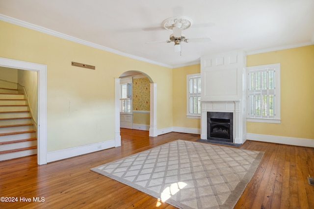 unfurnished living room with hardwood / wood-style flooring, crown molding, and ceiling fan