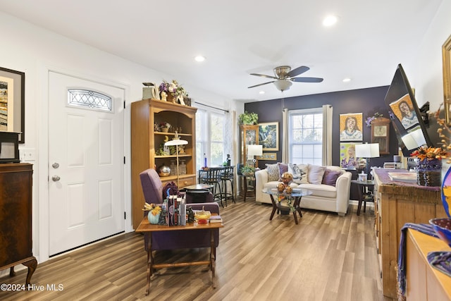 interior space with a ceiling fan, recessed lighting, and wood finished floors