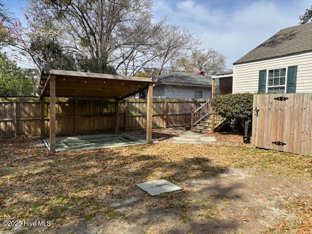 view of yard featuring stairs and a fenced backyard