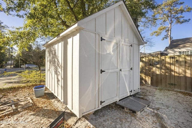 view of shed featuring fence