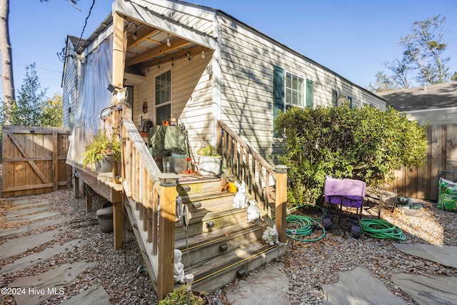 rear view of house featuring fence