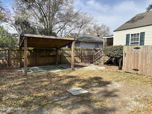 view of yard featuring stairway, a patio area, and a fenced backyard