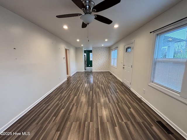 unfurnished living room with ceiling fan, baseboards, dark wood-style floors, and recessed lighting