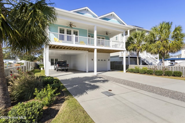 beach home featuring ceiling fan, a carport, and a garage